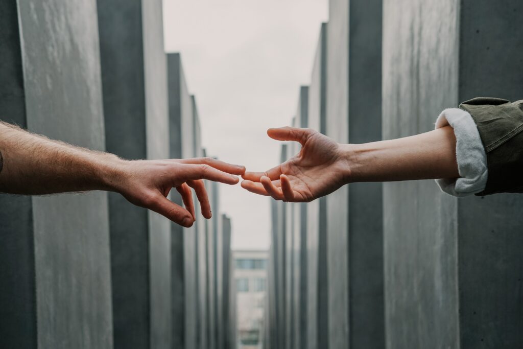 one hand approaching another hand to give shake hand